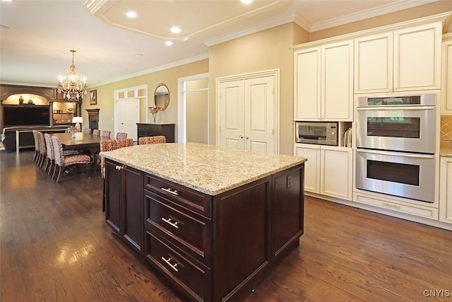 kitchen featuring stainless steel appliances, tasteful backsplash, dark hardwood / wood-style floors, light stone countertops, and dark brown cabinetry