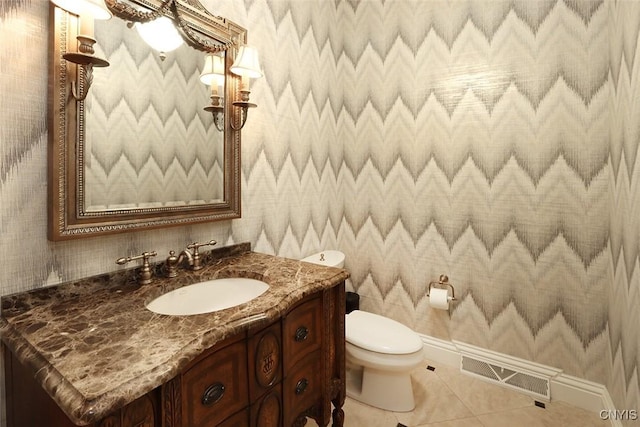 bathroom featuring toilet, vanity, and tile patterned floors