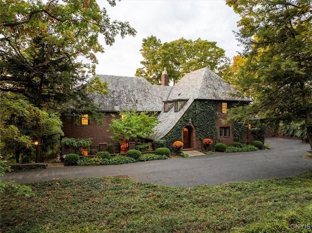 tudor-style house featuring a chimney