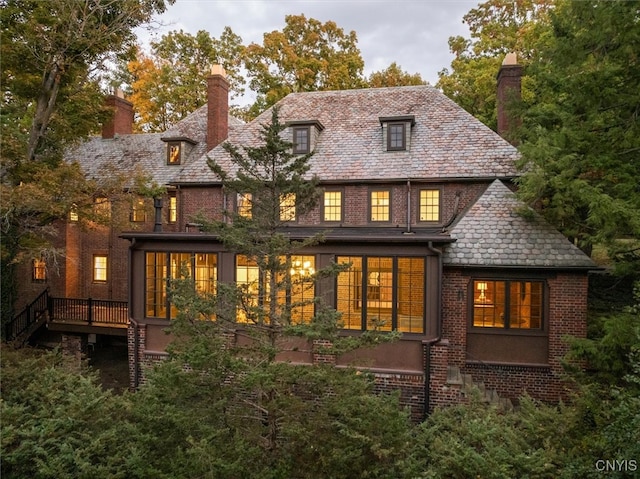 rear view of house featuring a deck