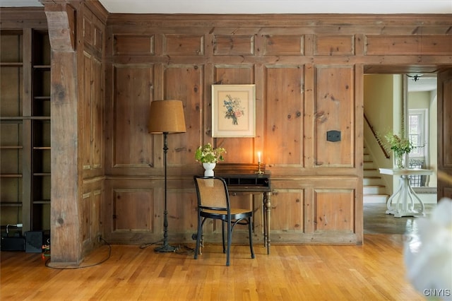 interior space featuring wooden walls and light wood-type flooring