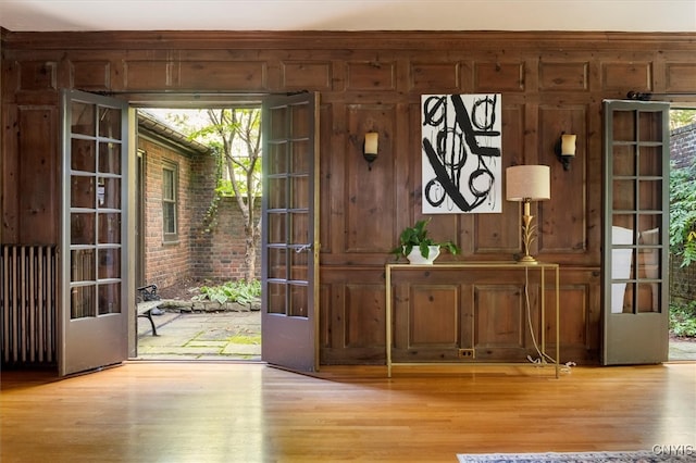 entryway with french doors, light wood-type flooring, and a wealth of natural light