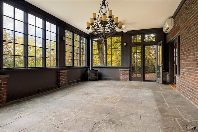 unfurnished sunroom with a wall mounted AC and ceiling fan with notable chandelier