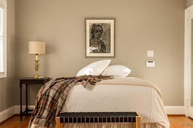 bedroom with wood finished floors and baseboards