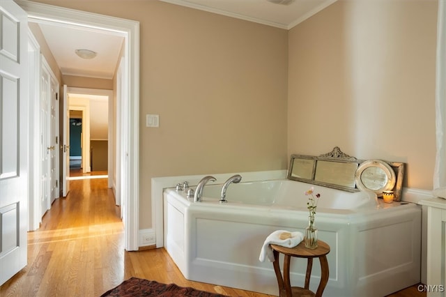 washroom with crown molding and light wood-type flooring