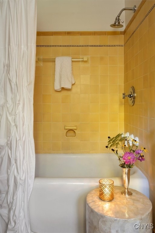 bathroom with shower / bath combination with curtain