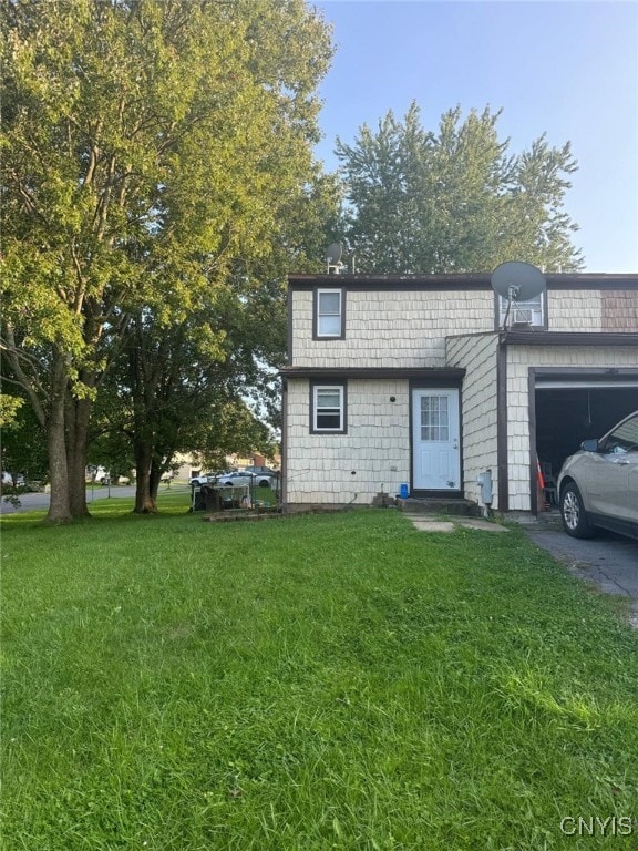 view of front of house featuring a garage and a front lawn