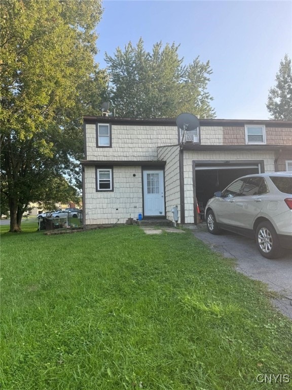 view of front of house with a garage and a front yard