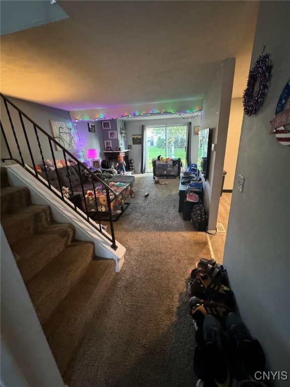 staircase featuring carpet flooring