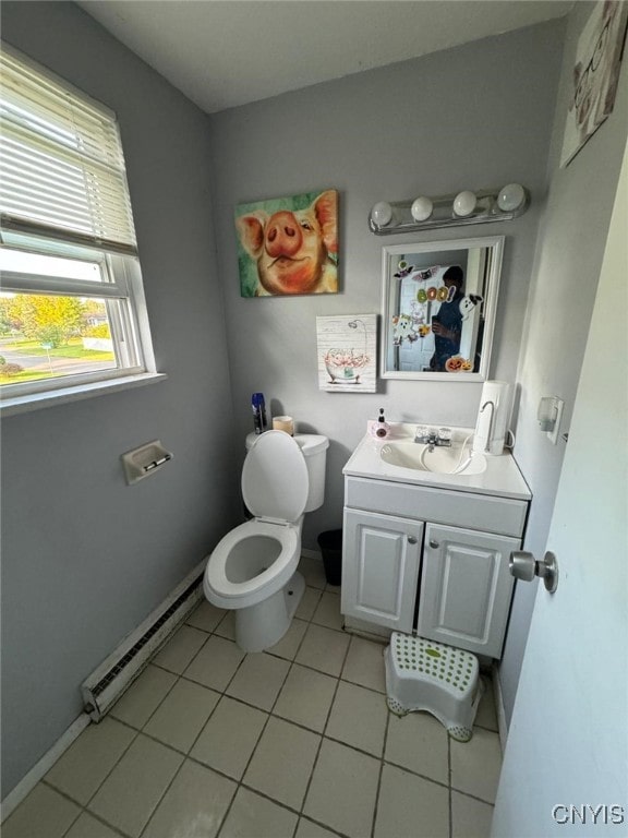 bathroom featuring vanity, a baseboard radiator, toilet, and tile patterned floors