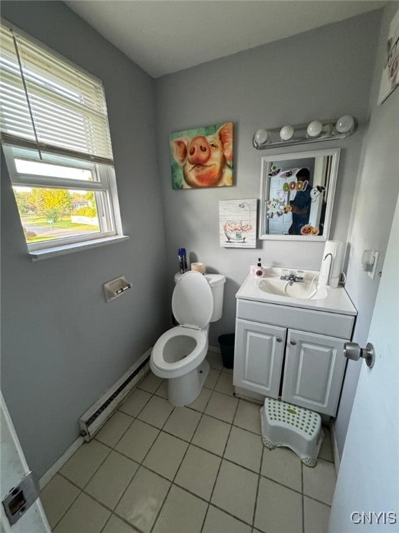 bathroom featuring tile patterned floors, toilet, vanity, and baseboard heating