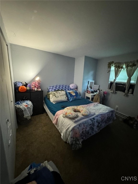 carpeted bedroom featuring baseboard heating