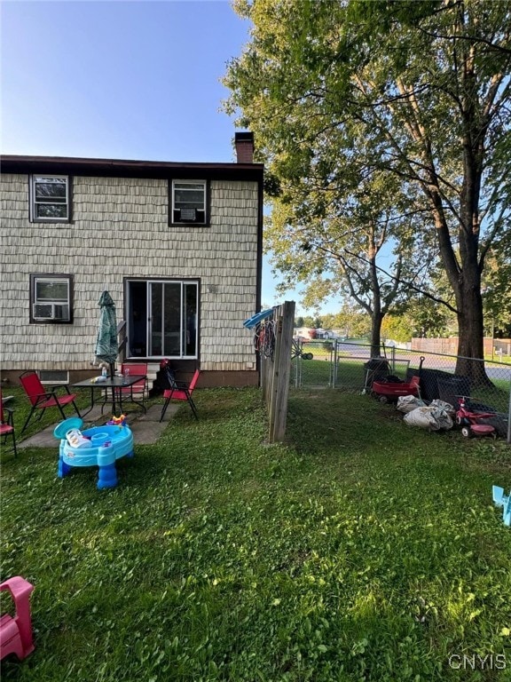 back of property with a patio and a yard