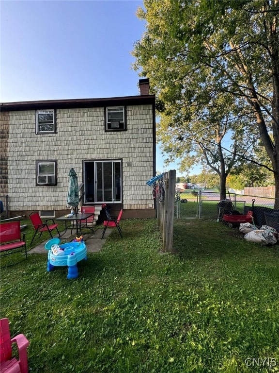 rear view of property featuring a yard and a patio