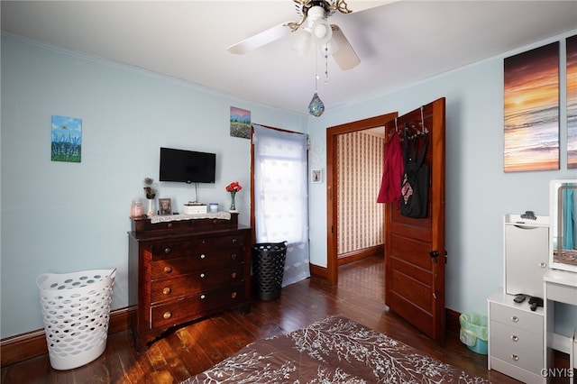 bedroom featuring ornamental molding, dark hardwood / wood-style flooring, and ceiling fan