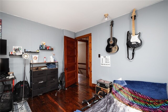 bedroom with dark wood-type flooring