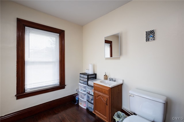 bathroom with hardwood / wood-style floors, toilet, and vanity