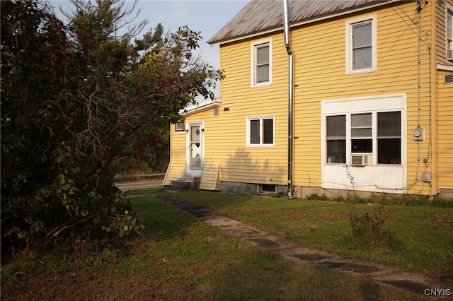 view of side of property with a lawn