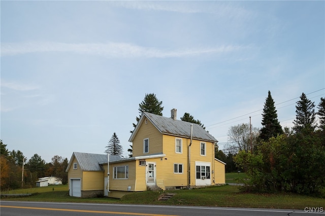 view of front of property with a front yard and a garage