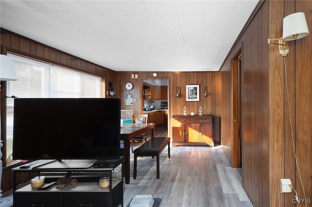 home office with wooden walls and light wood-type flooring