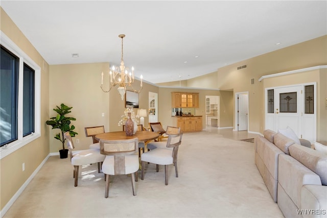 dining room featuring a chandelier and light carpet