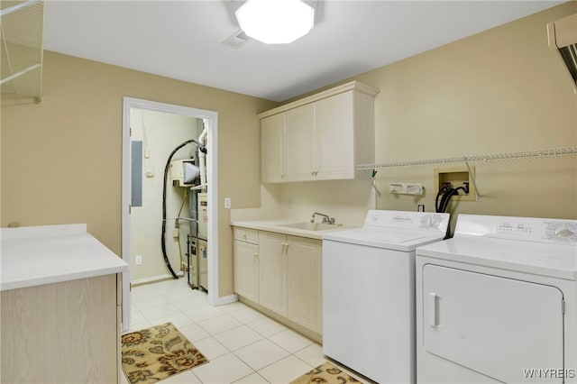 laundry area with washer and dryer, cabinets, light tile patterned floors, and sink