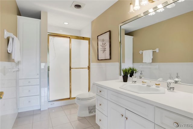 bathroom featuring tile patterned floors, vanity, walk in shower, and toilet