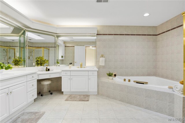 bathroom featuring vanity, plus walk in shower, tile patterned flooring, and tile walls