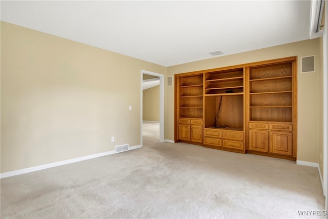 unfurnished living room featuring light colored carpet