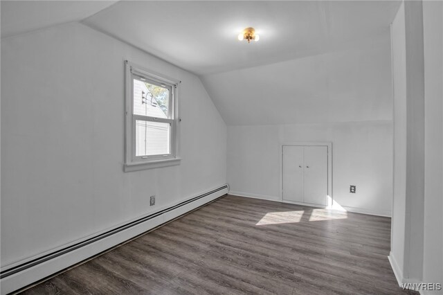 bonus room featuring baseboard heating, hardwood / wood-style floors, and lofted ceiling