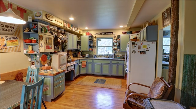 kitchen featuring white fridge and light hardwood / wood-style floors