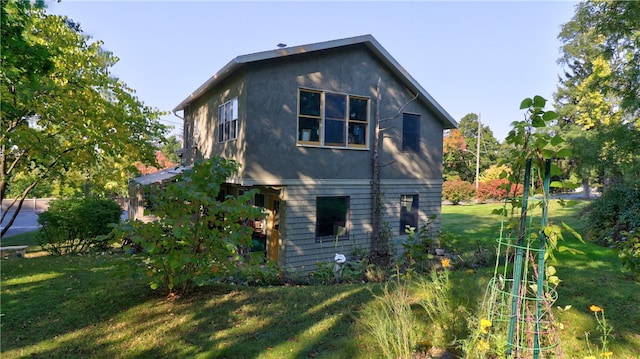 view of property exterior with a lawn