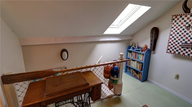 interior space featuring vaulted ceiling with skylight