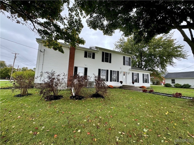 view of front of house with a front lawn and central AC unit