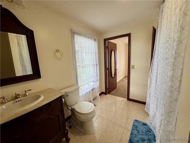 bathroom with vanity, toilet, and tile patterned flooring