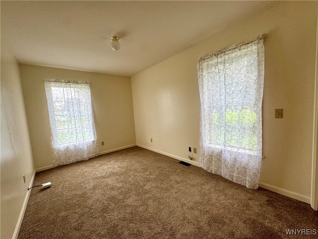 unfurnished room featuring carpet