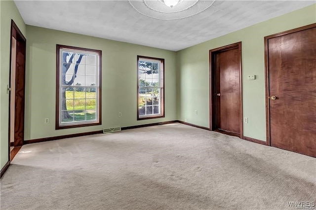 carpeted spare room featuring a textured ceiling