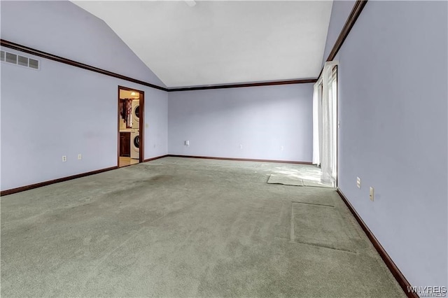 unfurnished room featuring crown molding, washer / clothes dryer, lofted ceiling, and carpet floors