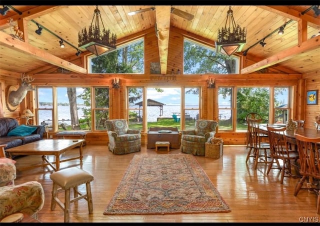 living area featuring rail lighting, hardwood / wood-style floors, and wood ceiling