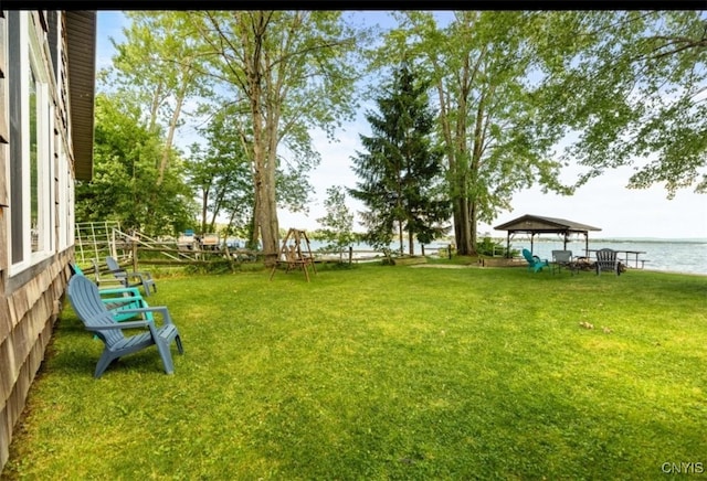 view of yard featuring a gazebo and a water view