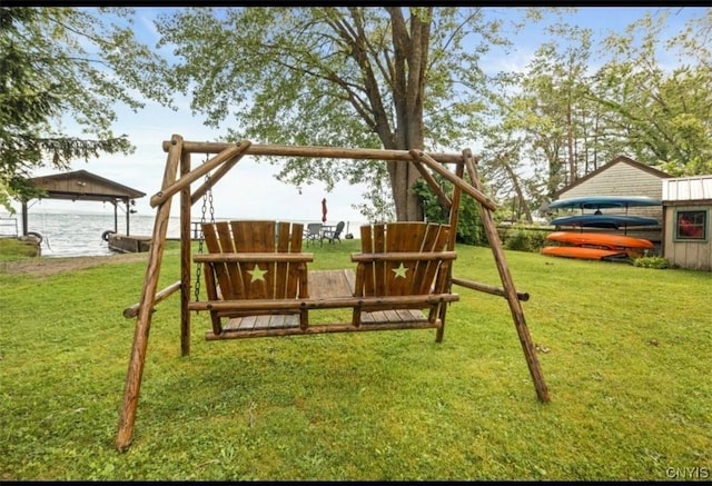 view of playground with a yard and a water view