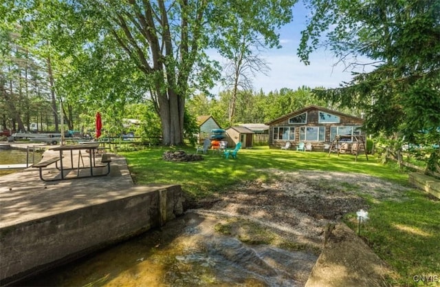 view of yard featuring an outdoor structure and a storage unit