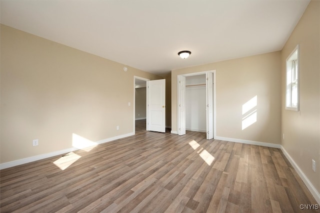 unfurnished bedroom featuring hardwood / wood-style flooring