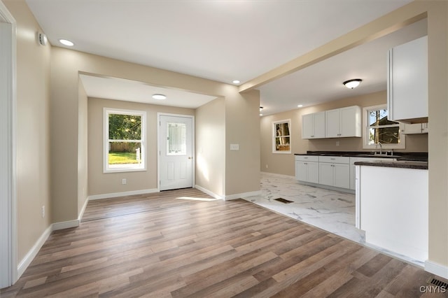 kitchen featuring white cabinets and light hardwood / wood-style flooring