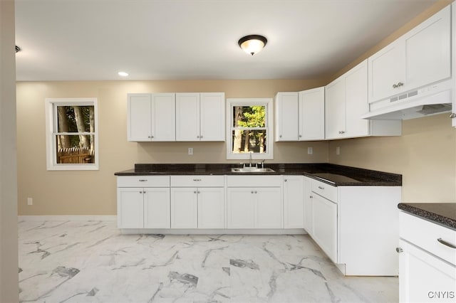 kitchen featuring sink and white cabinets