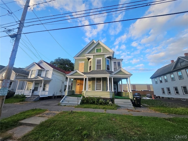 view of front of property with a front yard and covered porch