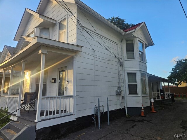 view of side of home with covered porch