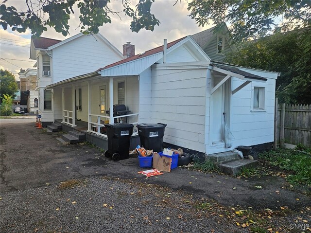 rear view of house featuring a porch