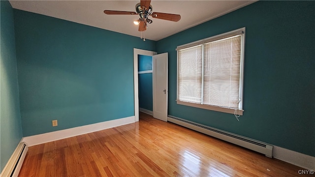 spare room with ceiling fan, light hardwood / wood-style floors, and a baseboard radiator