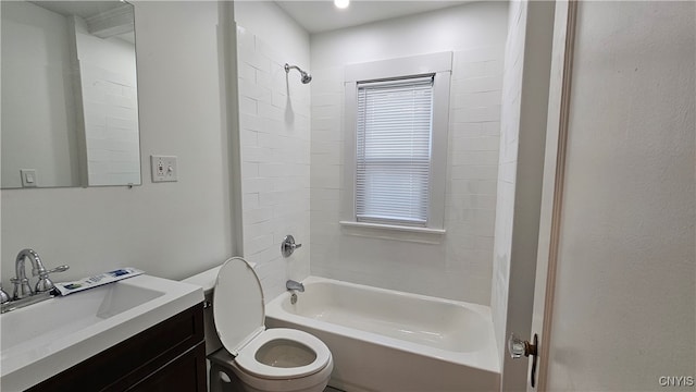 full bathroom featuring vanity, tiled shower / bath combo, and toilet